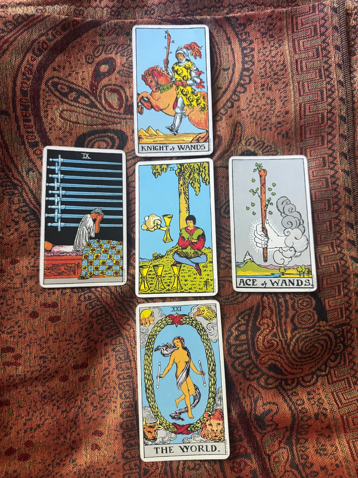 Knight of Wands, Nine of Swords, Four of Cups, Ace of Wands, and The World in a five-card spread.